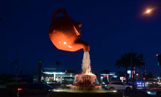 Water flows from the Soaring Teapot sculpture in Temple City, California on August 13, 2019. China is the world's largest producer of tea, another item among a number of products expected to get hit after the US slaps $300 billion of tariffs on Chinese imports in September. (Photo by Frederic J Brown/AFP Photo)