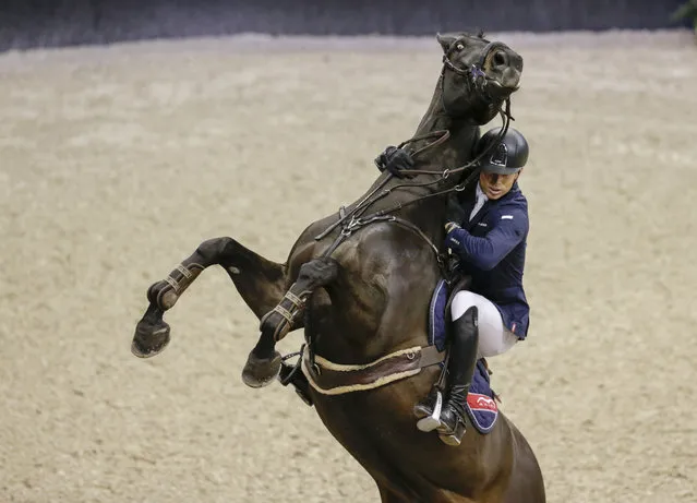 Austria's Max Kuhner hangs on to his horse Cornet Kalua, who balked at a jump in the FEI World Cup equestrian jumping speed class in Omaha, Neb., Thursday, March 30, 2017. (Photo by Nati Harnik/AP Photo)