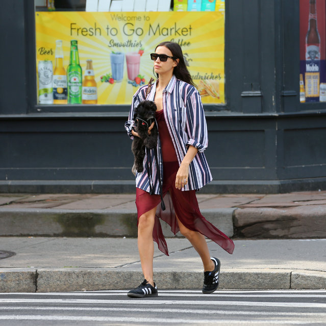 Russian fashion model Irina Shayk wears a sheer dress, striped shirt and Adidas sneakers in New York City on June 6, 2024. (Photo by Christopher Peterson/Splash News and Pictures)