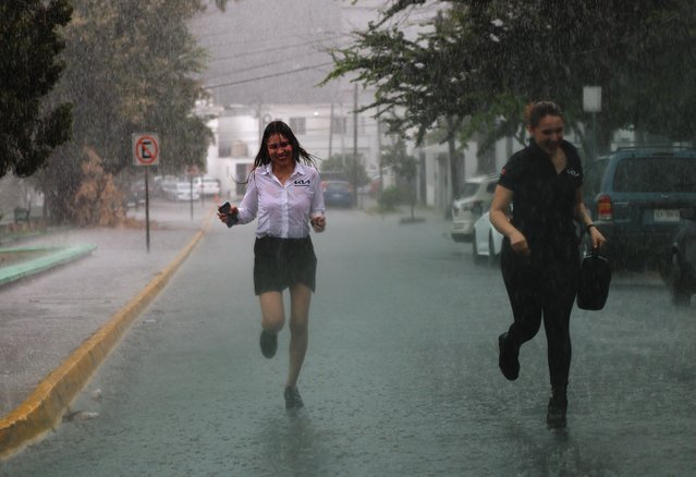 People run along a street as rain caused by tropical storm Alberto, the first named storm of 2024 Atlantic hurricane season, falls, in Monterrey, Mexico. on June 19, 2024. (Photo by Daniel Becerril/Reuters)