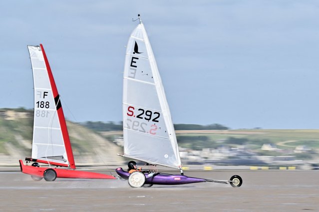 Sand yachting participants take part in a training session during the Sand Yacht World Championship on the beach in Asnelles, northwestern France, on June 28, 2024. From June 29 to July 5, 2024, the world sand yachting championships will be held in Asnelles (Calvados) and Gold Beach, after this World Championship has not been held for 6 years in Europe and 12 years in France. (Photo by Lou Benoist/AFP Photo)