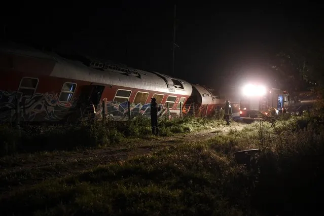 Rescuers search the site of a fatal train derailment close to the northern city of Thessaloniki, Greece on Sunday, May 14, 2017. The train was traveling on the Athens-Thessaloniki route when it went off the rails near the station at the village of Adendro, 40 kilometers (25 miles) west of Thessaloniki Saturday night. (Photo by Giannis Papanikos/AP Photo)