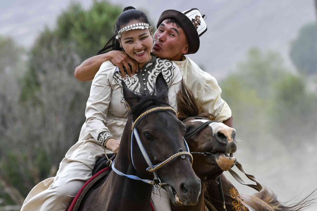 Kyrgyz riders attend the game “catch the girl” during the Traditional Eagle Hunting Festival Salbuurun near the Issyk-Kul lake on the southern shore of Issyk-Kul lake, 213 km (132 miles) southeast of Bishkek, Kyrgyzstan, Saturday,  August 3, 2024. (Photo by Vladimir Voronin/AP Photo)