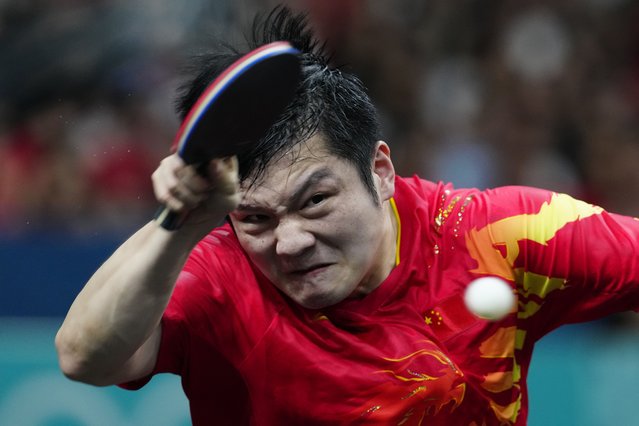 China's Fan Zhendong plays against Sweden's Truls Moregard during the men's gold medal team table tennis match at the 2024 Summer Olympics, Friday, August 9, 2024, in Paris, France. (Photo by Petros Giannakouris/AP Photo)