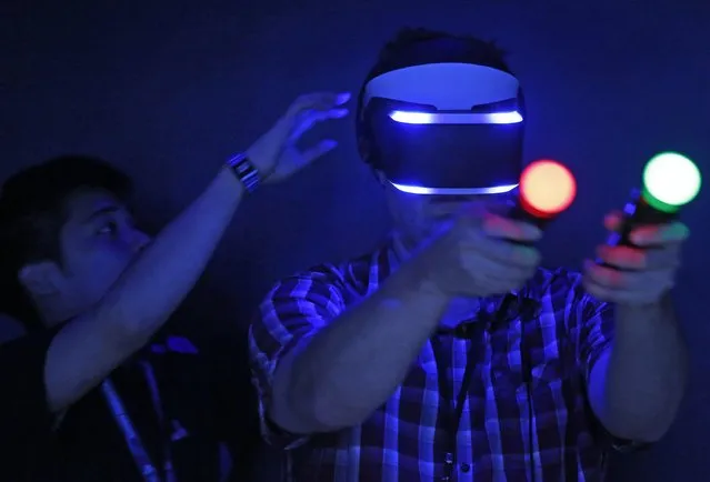 Paul Breakhow tries out the Sony "Project Morpheus" virtual reality system at the 2014 Electronic Entertainment Expo, known as E3, in Los Angeles, June 10, 2014.  REUTERS/Jonathan Alcorn