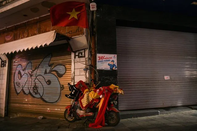 A person dressed as Sun Wukong (Monkey King) sleeps on a motor bike during the Lunar New Year celebration in Hanoi, Vietnam, February 2, 2022. (Photo by Chalinee Thirasupa/Reuters)