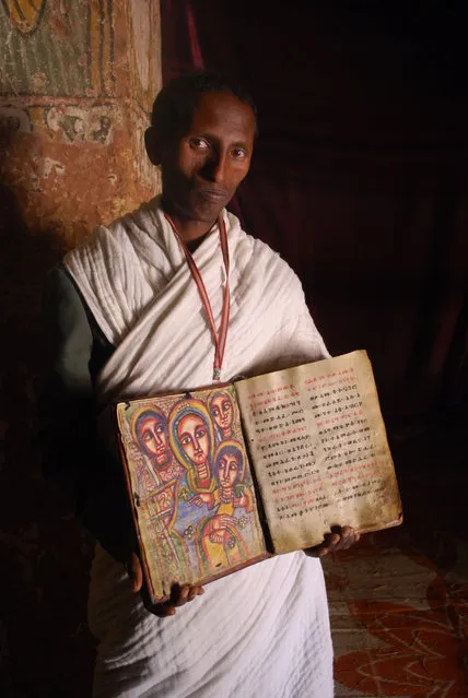 “The gate keeper”. It was a bit nerve wracking getting to the top of the church, but so worth it. The book being held is extremely old, and the images were stunning. Photo location: Abuna Yemata Guh church, Ethiopia. (Photo and caption by Kristen Eder/National Geographic Photo Contest)