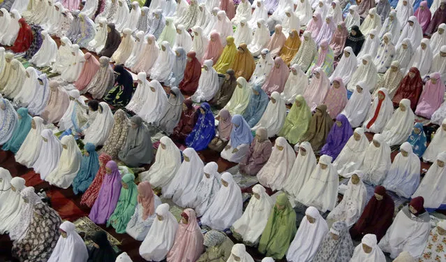 Muslim women perform an evening prayer called 'tarawih' marking the first eve of the holy fasting month of Ramadan, at Istiqlal Mosque in Jakarta, Indonesia, Sunday, June 5, 2016. (Photo by Tatan Syuflana/AP Photo)