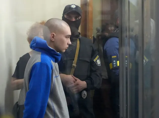 Russian army Sergeant Vadim Shishimarin, 21, is seen behind a glass during a court hearing in Kyiv, Ukraine, Friday, May 13, 2022. The trial of a Russian soldier accused of killing a Ukrainian civilian opened Friday, the first war crimes trial since Moscow's invasion of its neighbor. (Photo by Efrem Lukatsky/AP Photo)