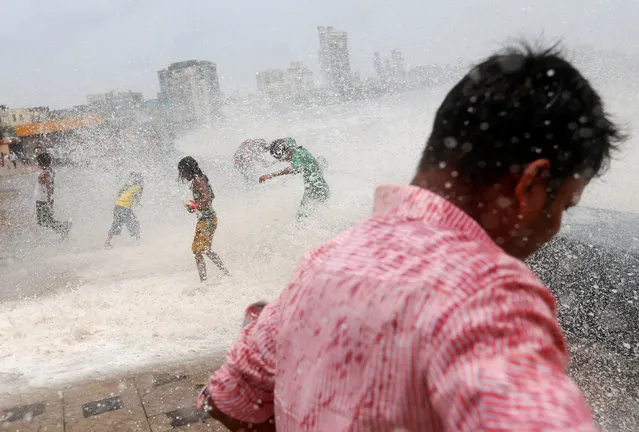 People get drenched in a large wave during high tide at a seafront in Mumbai, India June 6, 2016. (Photo by Danish Siddiqui/Reuters)