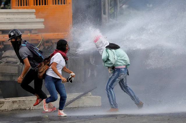 Demonstrators clash with riot security forces while rallying against Venezuela's President Nicolas Maduro's Government in Caracas, Venezuela, June 23, 2017. (Photo by Ivan Alvarado/Reuters)