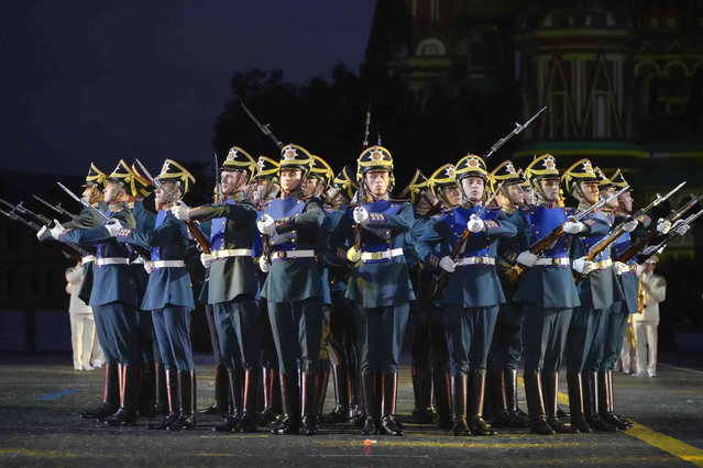 Russian soldiers of the Presidential regiment perform during the Spasskaya Tower International Military Music Festival at Red Square, with the St. Basil Cathedral in the background, in Moscow, Russia, Friday, August 23, 2024. (Photo by Alexander Zemlianichenko/AP Photo)