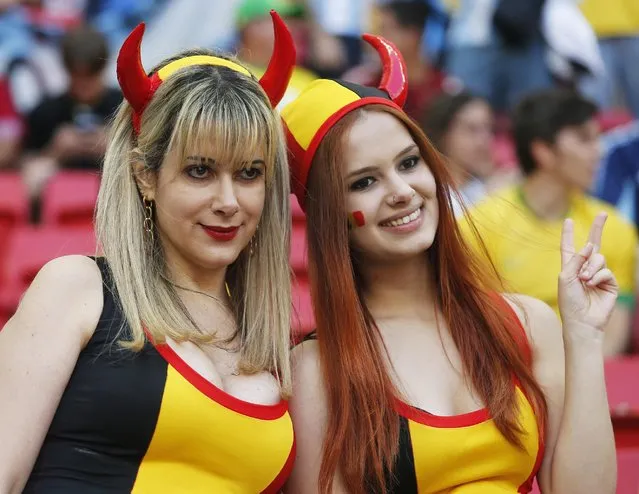 Belgium supporters pose before the World Cup quarterfinal soccer match between Argentina and Belgium at the Estadio Nacional in Brasilia, Brazil, Saturday, July 5, 2014. (Photo by Victor R. Caivano/AP Photo)