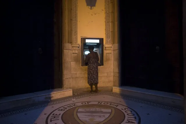 A woman uses an automated teller machine (ATM) in downtown Havana July 31, 2015. (Photo by Alexandre Meneghini/Reuters)