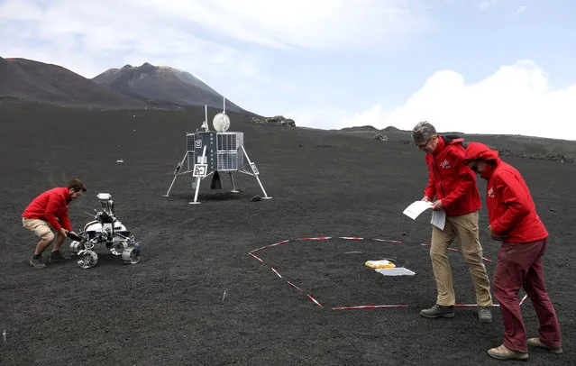 Scientists from German Aerospace Center are seen working as they test some robots on Mount Etna, Italy on July 4, 2017. (Photo by Antonio Parrinello/Reuters)