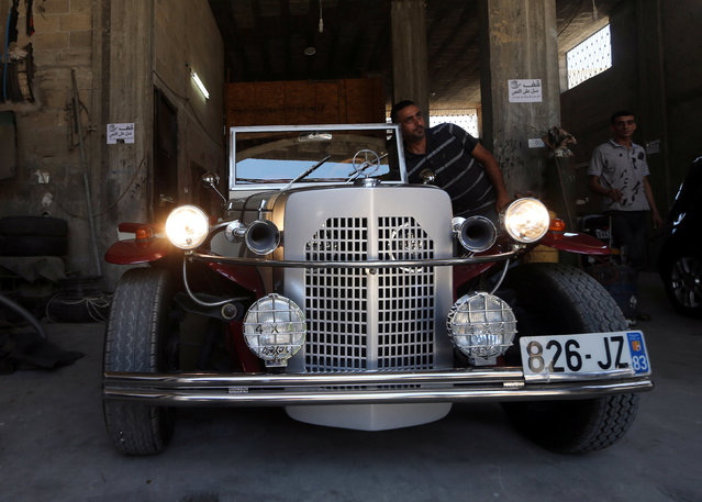 Palestinian Munir Shindi, 36, checks a replica of a 1927 Mercedes Gazelle that he built from scratch, in his workshop in Gaza City June 19, 2016. (Photo by Mohammed Salem/Reuters)