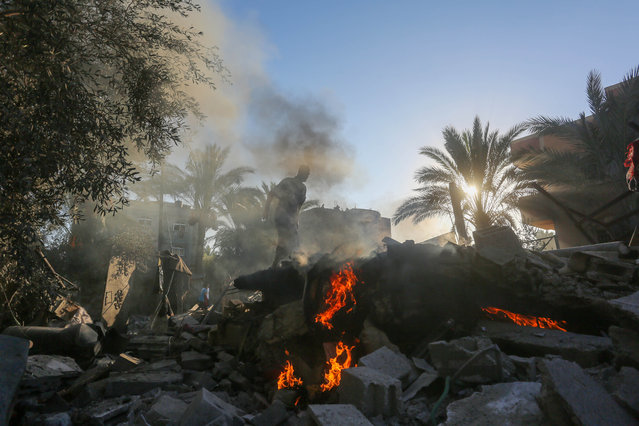 Civil defense teams and local Palestinians work to retrieve the dead and injured from the area following an Israeli army attack on the home of the Jabir family in the city of Deir al-Balah, located in central Gaza, on October 4, 2024. (Photo by Ashraf Amra/Anadolu via Getty Images)