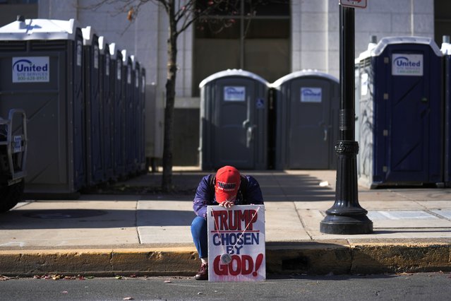 A person sits outside the site of a Republican presidential nominee former President Donald Trump campaign rally in Allentown, Pa., Tuesday, October 29, 2024. (Photo by Matt Rourke/AP Photo)