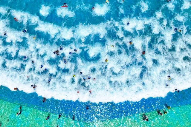 This aerial photo taken on July 24, 2022 shows people cooling off at a water park amid hot weather in Lianyungang in China's eastern Jiangsu province. (Photo by AFP Photo/China Stringer Network)