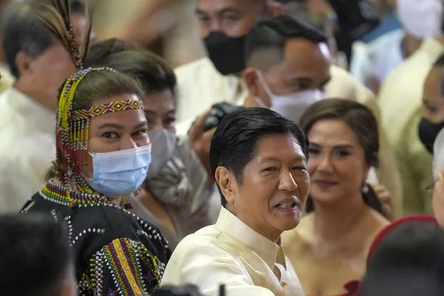 New Philippine President Ferdinand Marcos Jr., center, stands beside Vice President Sara Duterte, left, in a traditional tribal dress after his first state of the nation address in Quezon city, Philippines, Monday, July 25, 2022. Marcos Jr. delivered his first State of the Nation address Monday with momentum from his landslide election victory, but he's hamstrung by history as an ousted dictator’s son and daunting economic headwinds. (Photo by Aaron Favila/Pool via AP Photo)