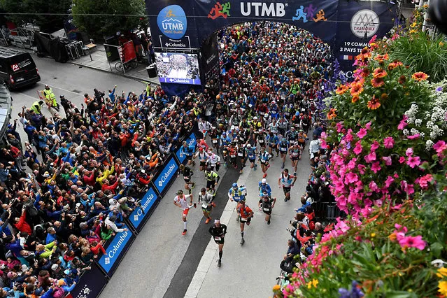 2300 runners wait for the start of the 170 km Mount Blanc Ultra Trail (UTMB) race around the Mont- Blanc crossing France, Italy and Swiss, on September 1, 2017 in Chamonix. (Photo by Jean-Pierre Clatot/AFP Photo)