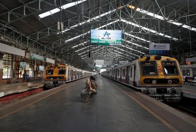 Passenger trains are parked at Chhatrapati Shivaji Maharaj Terminus railway station during a 14-hour long curfew to limit the spreading of coronavirus disease (COVID-19) in the country, in Mumbai, India, March 22, 2020. (Photo by Francis Mascarenhas/Reuters)