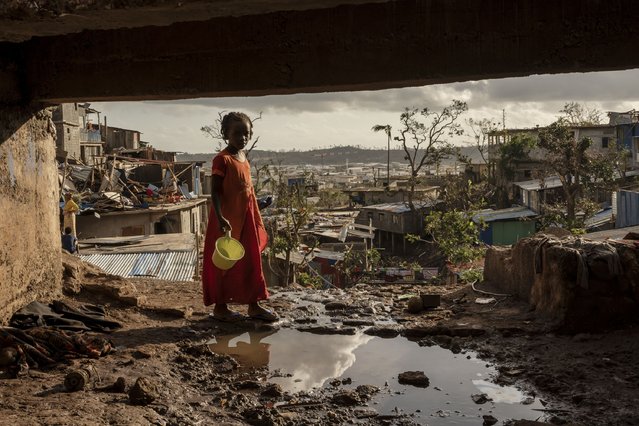 A young girl walks in the Kaweni slum on the outskirts of Mamoudzou, in the French Indian Ocean island of Mayotte, Thursday, December 19, 2024, after Cyclone Chido. (Photo by Adrienne Surprenant/AP Photo)
