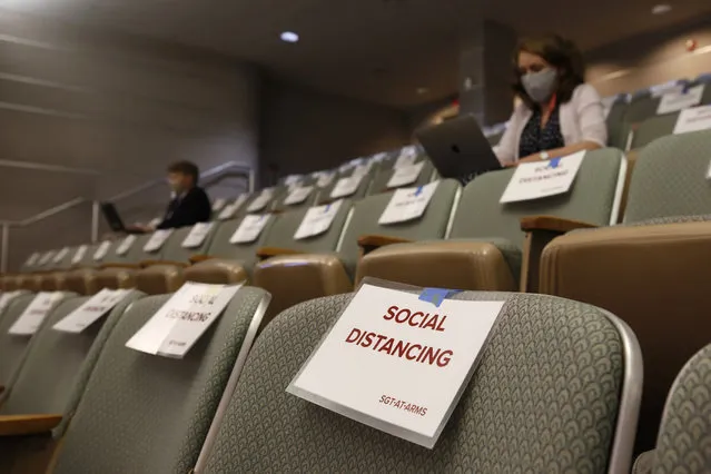 Signs remind members of the media “press pool” to practice social distancing during a hearing of the state Senate budget special subcommittee on COVID-19, at the Capitol in Sacramento, Calif., Thursday, April 16, 2020. Lawmakers are looking into how Gov. Gavin Newsom has been spending money to address the new coronavirus crisis. (Photo by Rich Pedroncelli/AP Photo/Pool)