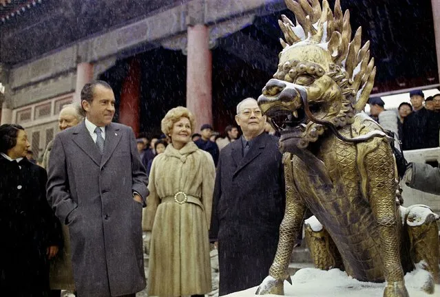 Then U.S. President Richard Nixon and then first lady Pat Nixon looks at a sculpture depicting a mythical beast on the palace grounds of Beijing's Forbidden City as heavy snow falls on February 25, 1972. At the height of the Cold War, U.S. President Richard Nixon flew into communist China's center of power for a visit that over time would transform U.S.-China relations and China's position in the world in ways that were unimaginable at the time. (Photo by AP Photo, File)