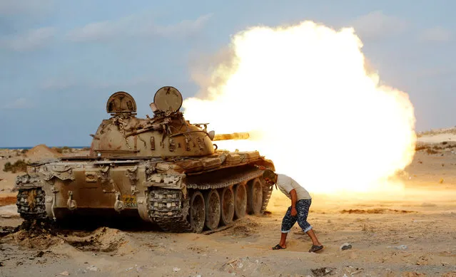 A fighter of Libyan forces allied with the U.N.-backed government fires a shell with Soviet made T-55 tank at Islamic State fighters in Sirte, Libya, August 2, 2016. (Photo by Goran Tomasevic/Reuters)