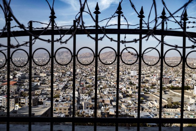 A general view shows the cityscape through a wall fence at the Wazir Akbar Khan hilltop in Kabul on November 25, 2024. (Photo by Wakil Kohsar/AFP Photo)