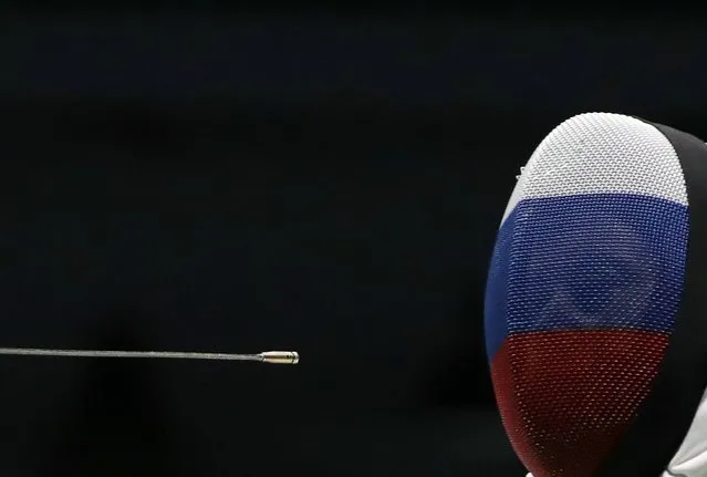 Russia's Tatiana Logunova moves away from the epee tip of France's Marie-Florence Candassamy as they compete during the women's epee team fencing quarterfinal competition of the 2016 Summer Olympics in Rio de Janeiro, Brazil, Thursday, August 11, 2016. (Photo by Gregory Bull/AP Photo)