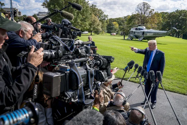 President Donald Trump calls on a reporter before boarding Marine One on the South Lawn of the White House in Washington, Wednesday, October 25, 2017, for a short trip to Andrews Air Force Base, Md. and then on to Dallas. (Photo by Andrew Harnik/AP Photo)