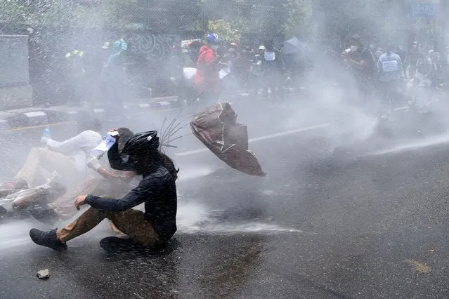 Police use water cannon to disperse demonstrators protesting against the governments policy on the fight against the COVID-19 coronavirus situation, in Kathmandu on June 9, 2020. (Photo by Prakash Mathema/AFP Photo)