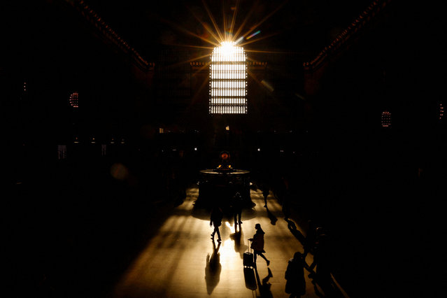 People walk in silhouette through Grand Central Station during morning time in New York City on February 24, 2025. (Photo by Shannon Stapleton/Reuters)
