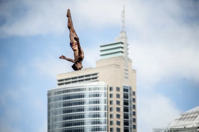 In this handout image provided by Red Bull, Jonathan Paredes of Mexico dives from the 27.5 metre platform during the first competition day of the eighth and final stop of the Red Bull Cliff Diving World Series on October 14, 2022 at Sydney, Australia. (Photo by Dean Treml/Red Bull via Getty Images)