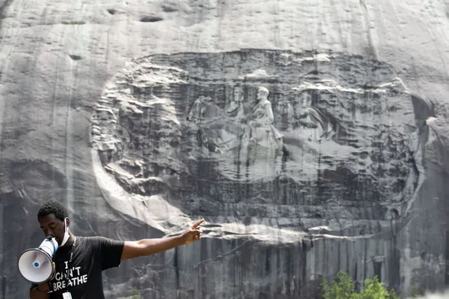 Organizer Quintavious Rhodes addresses Black Lives Matter protestors during a march in Stone Mountain Park to the Confederate carving etched into the stone side of the mountain on June 16, 2020 in Stone Mountain, Georgia. The march is to protest confederate monuments and recent police shootings.  Stone Mountain Park features a Confederate Memorial carving depicting Stonewall Jackson and Robert E. Lee, President Jefferson Davis. (Photo by Jessica McGowan/Getty Images)