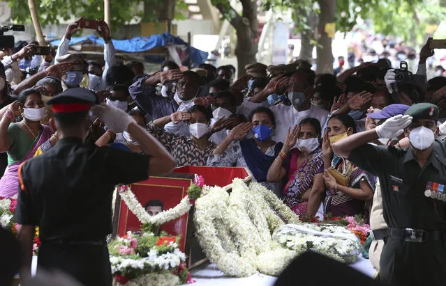 Indian army soldiers and family members pay tribute to Colonel B. Santosh Babu during a funeral at his home town at Suryapet, about 140 kilometers from Hyderabad, India, Thursday, June 18, 2020. Babu was among the twenty Indian troops who were killed in the clash Monday night that was the deadliest conflict between the sides in 45 years. India on Thursday cautioned China against making “exaggerated and untenable claims” to the Galvan Valley area even as both nations tried to end a standoff in the high Himalayan region where their armies engaged in a deadly clash. (Photo by Mahesh Kumar A./AP Photo)
