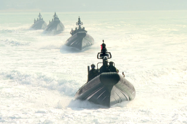 In this image taken from video, assault boats take part in naval drills in Kaohsiung, Southern Taiwan on Wednesday, January 31, 2024. Taiwan is holding spring military drills following its recent presidential election and amid threats from China, which claims the island as its own territory that it is determined to annex, possibly by force. (Photo by Johnson Lai/AP Photo)