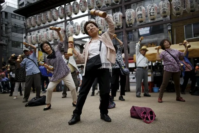 Elderly and middle-age people exercise with wooden dumbbells during a health promotion event to mark Japan's “Respect for the Aged Day” at a temple in Tokyo's Sugamo district, an area popular among the Japanese elderly, September 21, 2015. (Photo by Issei Kato/Reuters)