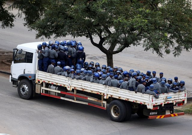 Anti-riot police officers are transported on a truck in the capital Harare, Zimbabwe on March 31, 2025. (Photo by Philimon Bulawayo/Reuters)