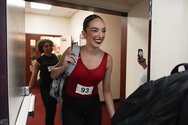 A dancer enters a rehearsal hall before an audition for the Radio City Rockettes at Radio City Music Hall, Tuesday, April 22, 2025, in New York. (Photo by Julia Demaree Nikhinson/AP Photo)