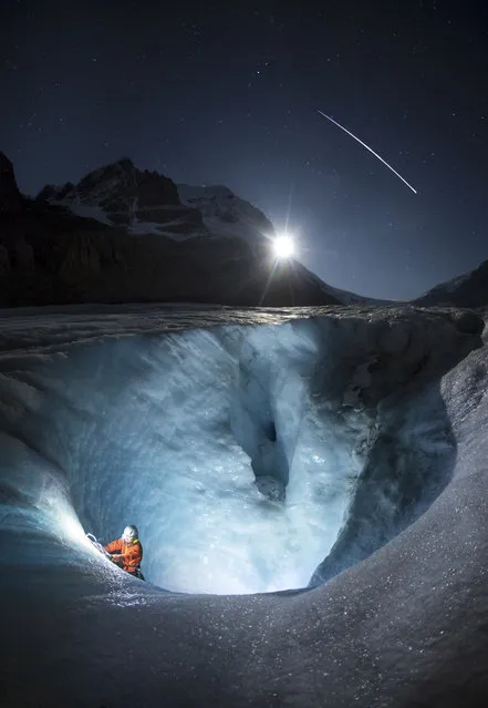 Paul Zizka night climbing at Athabasca Glacier in the Canadian Rockies as the ISS in orbit in the background. (Photo by Paul Zizka/Caters News Agency)