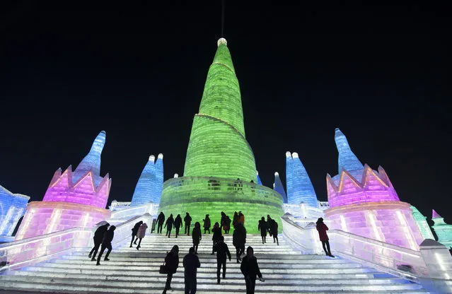 Tourists visit illuminated ice sculptures at Ice and Snow World park on January 4, 2018 in Harbin, China. (Photo by Tao Zhang/Getty Images)