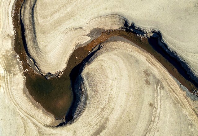 A drone view shows a water channel running through a dry section of the Woodhead Reservoir after a prolonged period without rain, which resulted in water levels dropping, near Tintwistle, Britain on May 13, 2025. (Photo by Phil Noble/Reuters)