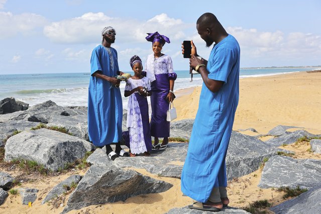 A family poses for photograph at a beach after Eid al-Adha prayers in Keta, Ghana, Friday, Jun 6, 2025 (Photo by Misper Apawu/AP Photo)