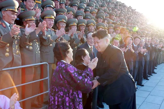 North Korean leader Kim Jong Un greets a woman during a photo session with delegates for the celebrations of the 70th anniversary of the ruling Workers' Party of Korea (WPK), in this undated photo released by North Korea's Korean Central News Agency (KCNA) in Pyongyang on October 14, 2015. (Photo by Reuters/KCNA)
