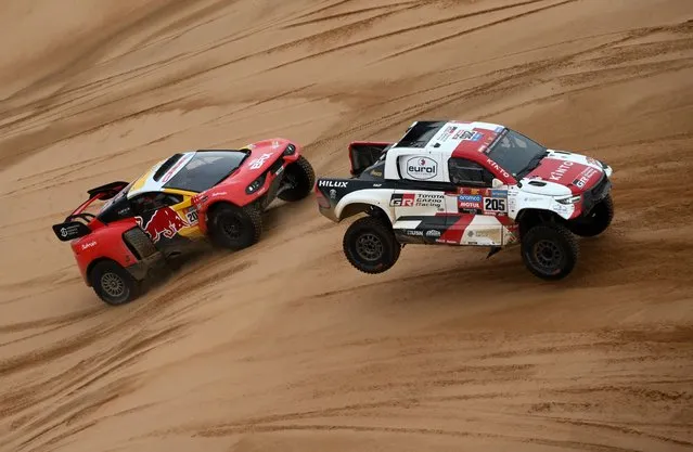 Toyota's driver Giniel De Villiers and his co-driver Dennis Murphy of South Africa and French driver Sebastien Loeb with his Belgian co-driver Fabian Lurquin compete during the Stage 8 of the Dakar 2023, between Al Duwadimi and Riyadh, on January 8, 2023. (Photo by Franck Fife/AFP Photo)