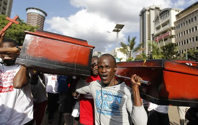 Protesters carry coffins during the #OccupyHarambeeAve protest in Kenya's capital Nairobi November 25, 2014. (Photo by Thomas Mukoya/Reuters)