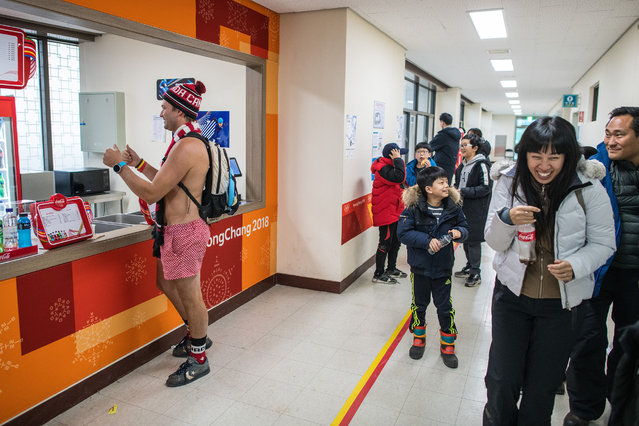 People react as a Canadian man wearing only a pair of shorts orders a drink from a fast food outlet in Gangneung Curling Centre on day 10 of the PyeongChang 2018 Winter Olympic Games on February 19, 2018 in Gangneung, South Korea. (Photo by Carl Court/Getty Images)